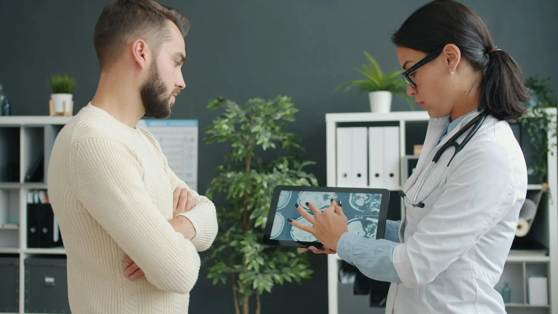 A doctor showing a patient their results on a tablet