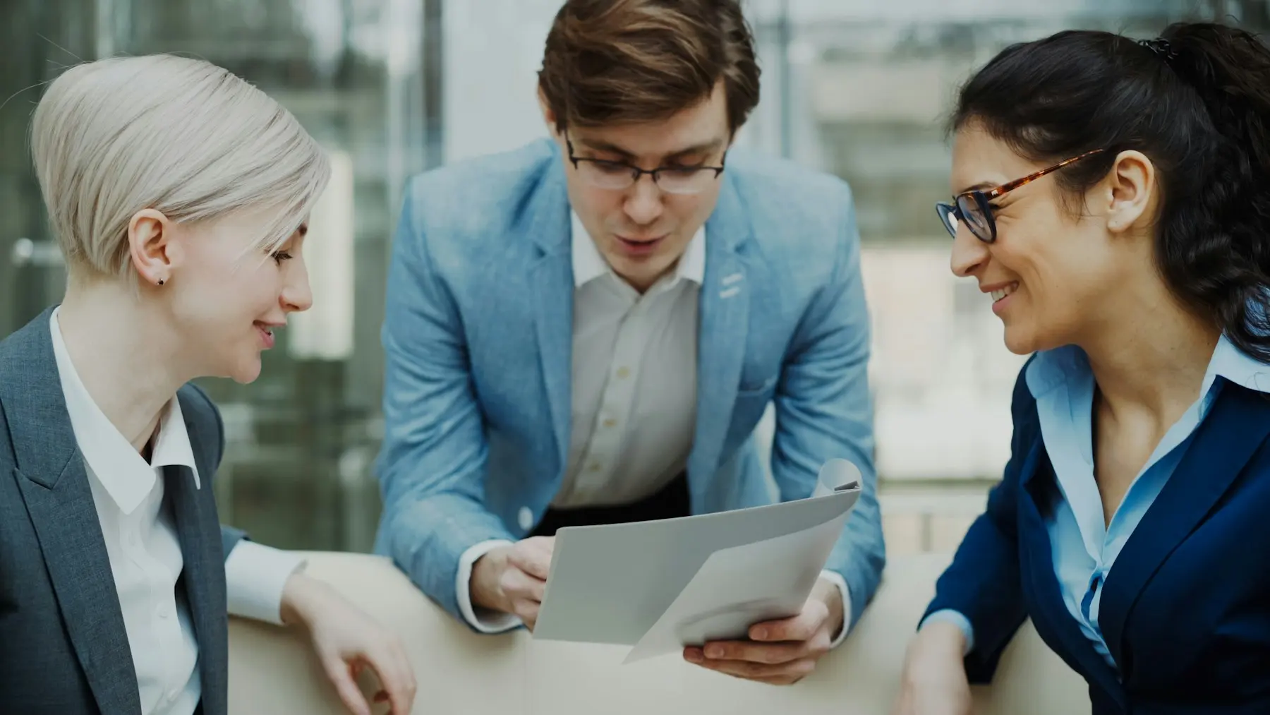Three colleagues reviewing a contract together
